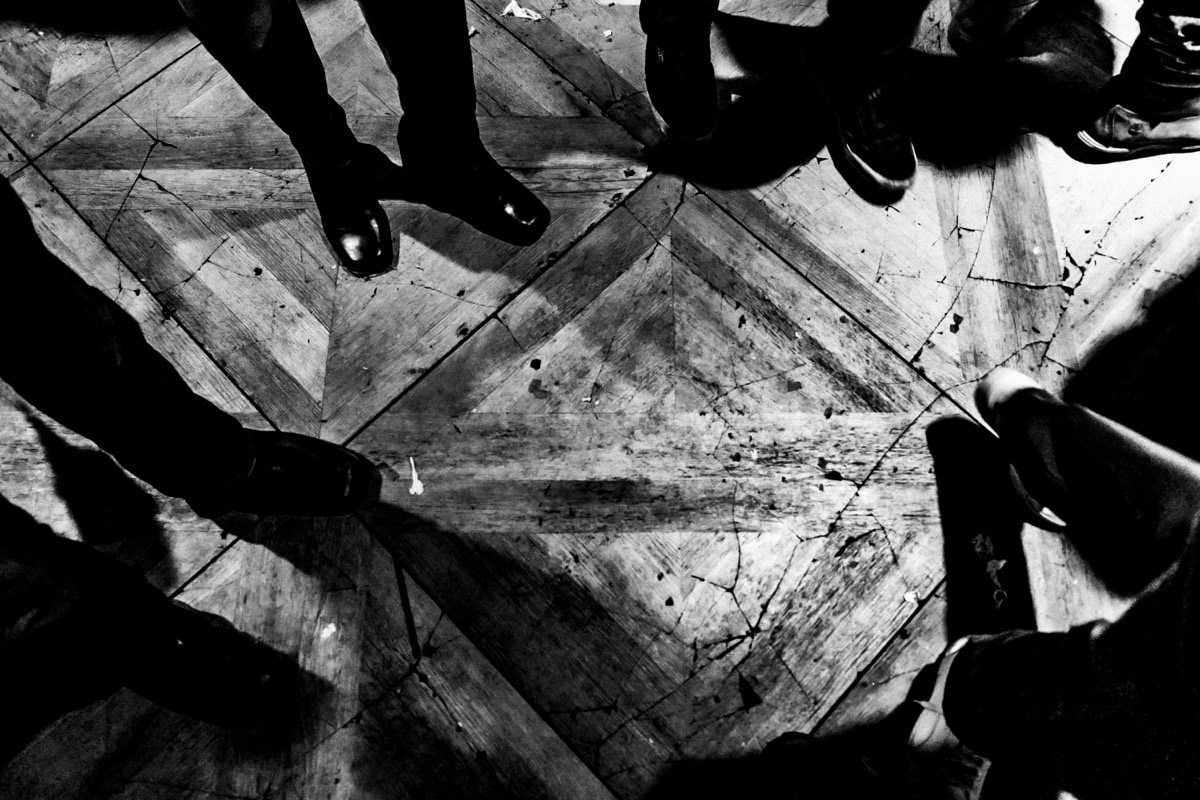 La Bestia — a cracked parquet dance floor in a dark club, shot from above