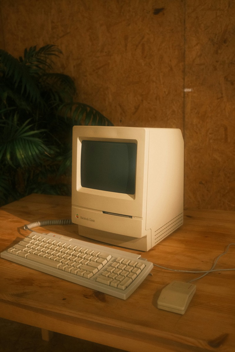 Memory Station '03 — a vintage beige Macintosh Classic on a wood desk
